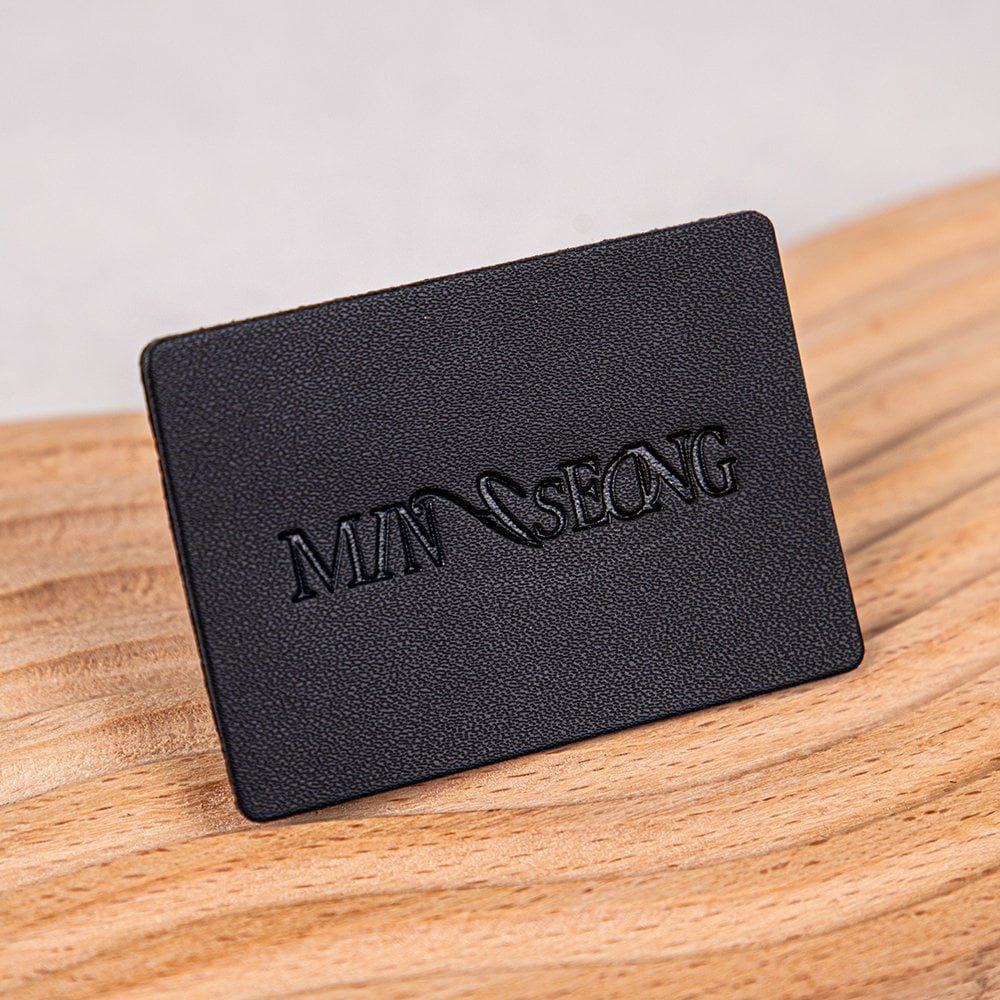 Wholesales Supplier Custom Logo Debossed Sew Garment Label PU Leather Laser Cut Washable Patches for Clothing and Bags Industry
