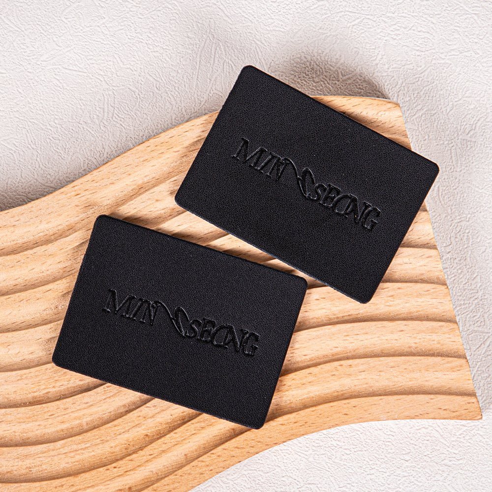 Wholesales Supplier Custom Logo Debossed Sew Garment Label PU Leather Laser Cut Washable Patches for Clothing and Bags Industry