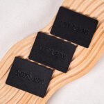 Wholesales Supplier Custom Logo Debossed Sew Garment Label PU Leather Laser Cut Washable Patches for Clothing and Bags Industry
