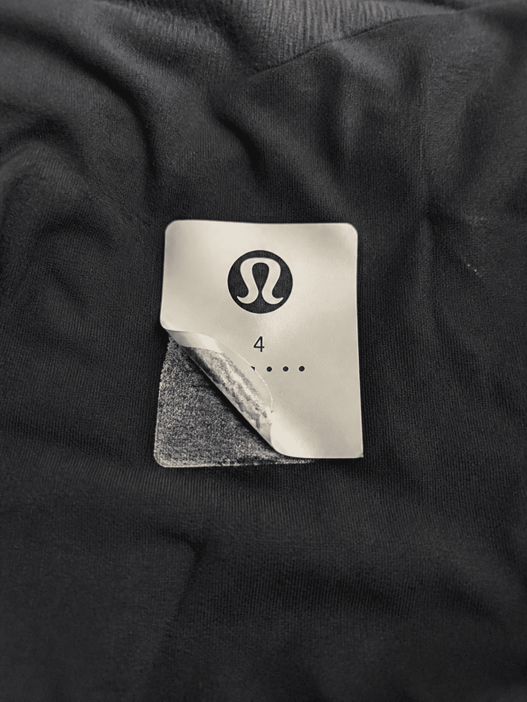 Faded satin garment label after repeated washing faded garment label on satin substrate