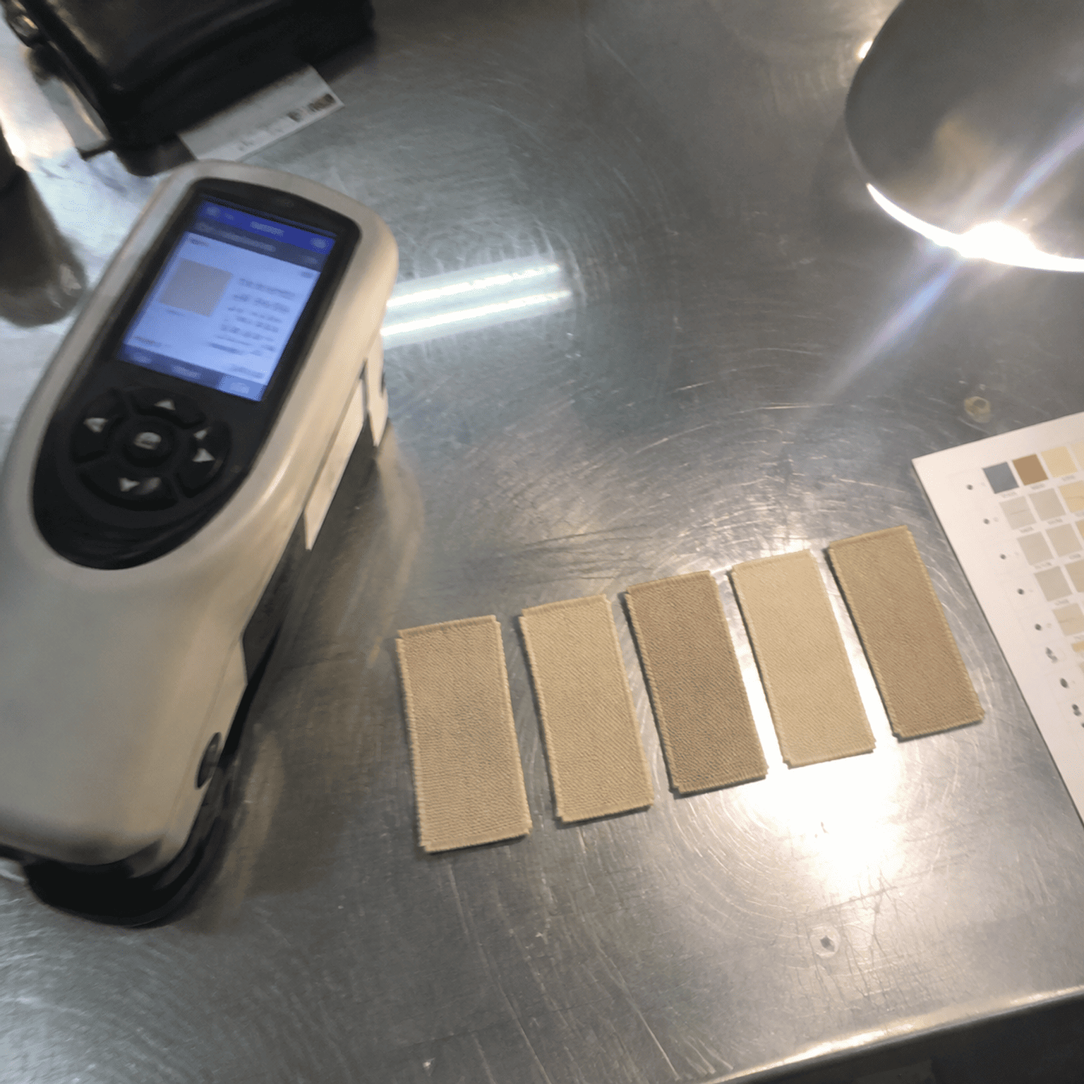 Quality control batch color consistency check on woven label yarns batch color consistency testing for garment trim production